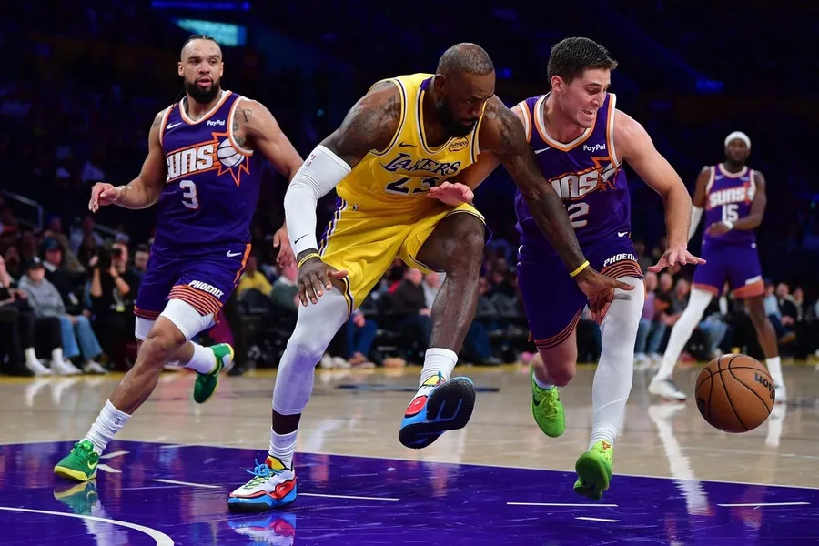 Los Angeles Lakers forward LeBron James (23) plays for the ball against Phoenix Suns guard Collin Gillespie (12)